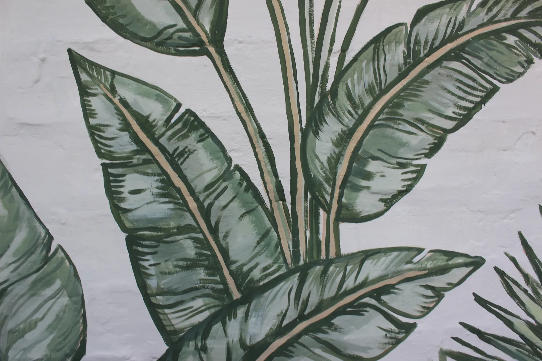 Detail of green leaves in the home's backyard mural